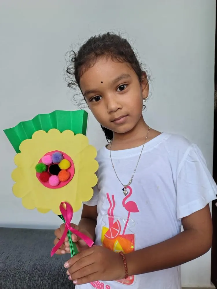 Student with a workshop paper bouquet